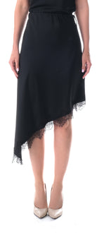 Black satin midi skirt on model showing asymmetric hemline by Lord & Taylor Heritage