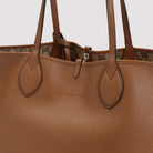Brown grained leather texture detail of Gucci Totissima tote bag by Gucci