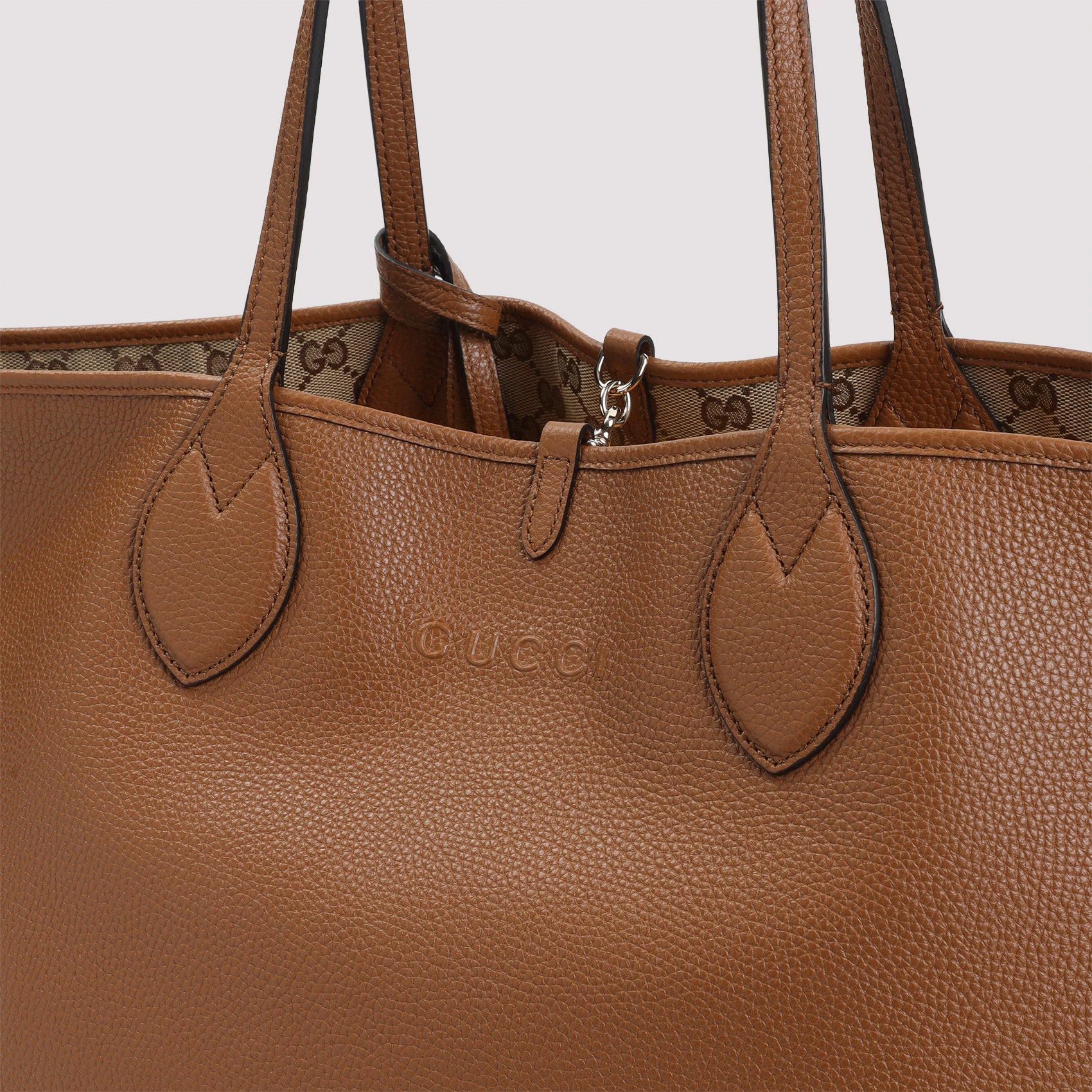 Brown grained leather texture detail of Gucci Totissima tote bag by Gucci