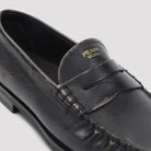 Black aged-effect leather loafer by Prada, interior view