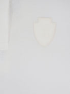 White Brunello Cucinelli cotton polo shirt with front logo patch, close-up