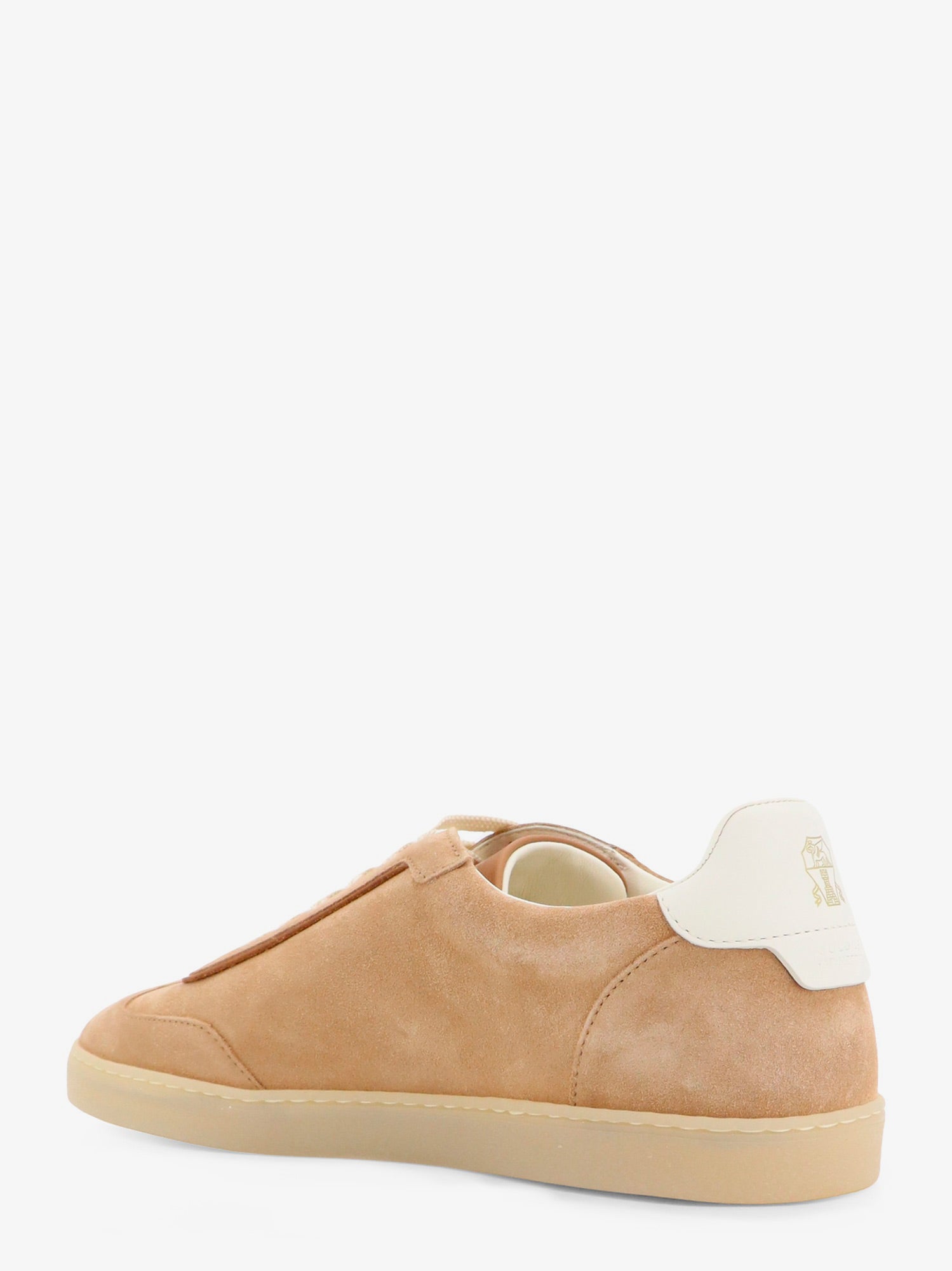 Beige suede sneakers by Brunello Cucinelli showing leather heel patch, rear view