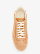 Beige low-top sneakers by Brunello Cucinelli with rubber sole, bottom view