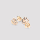 White Bottega Veneta knotted stud earrings showing crystal embellishment detail