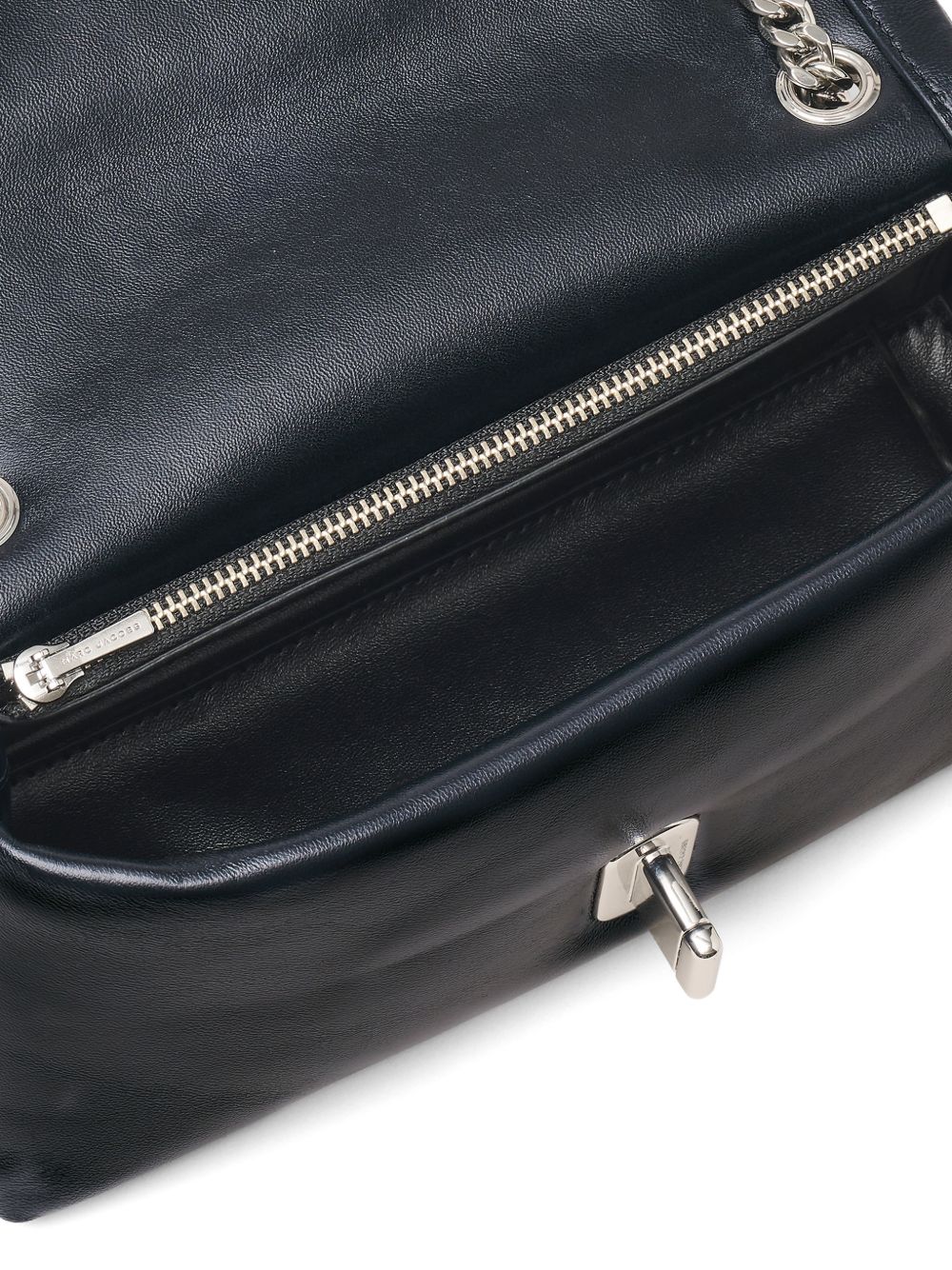 Black leather Marc Jacobs mini bag, side profile showing chain strap