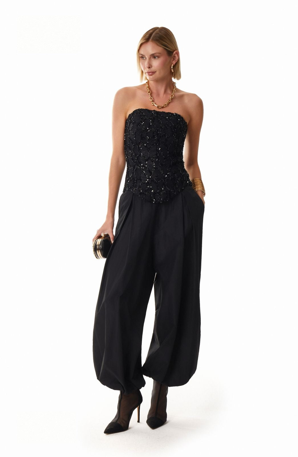 Black sculptural balloon-hem trousers with tapered leg, studio shot by Lord & Taylor Heritage