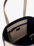 Beige canvas shoulder bag by Polo Ralph Lauren, side angle showing leather trim