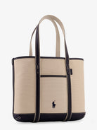 Beige canvas shoulder bag by Polo Ralph Lauren, close-up of leather trim detail