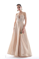Champagne beaded ball gown with floor-length skirt, studio shot