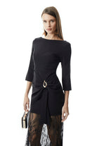 Black formal gown showing gathered hip draping and gold buckle detail