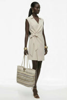 Stone beige wrap dress styled with accessories by Lord & Taylor Heritage