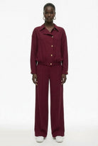 Burgundy collared bomber jacket styled with matching trousers, full outfit view