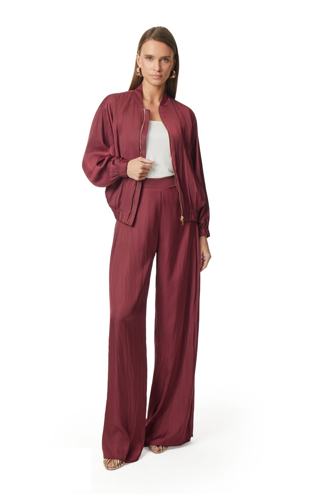 Burgundy satin bomber jacket styled with matching trousers and white camisole by Lord & Taylor Heritage