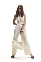 Cream sleeveless wrap jumpsuit with wide-leg trousers by Lord & Taylor Heritage, on model