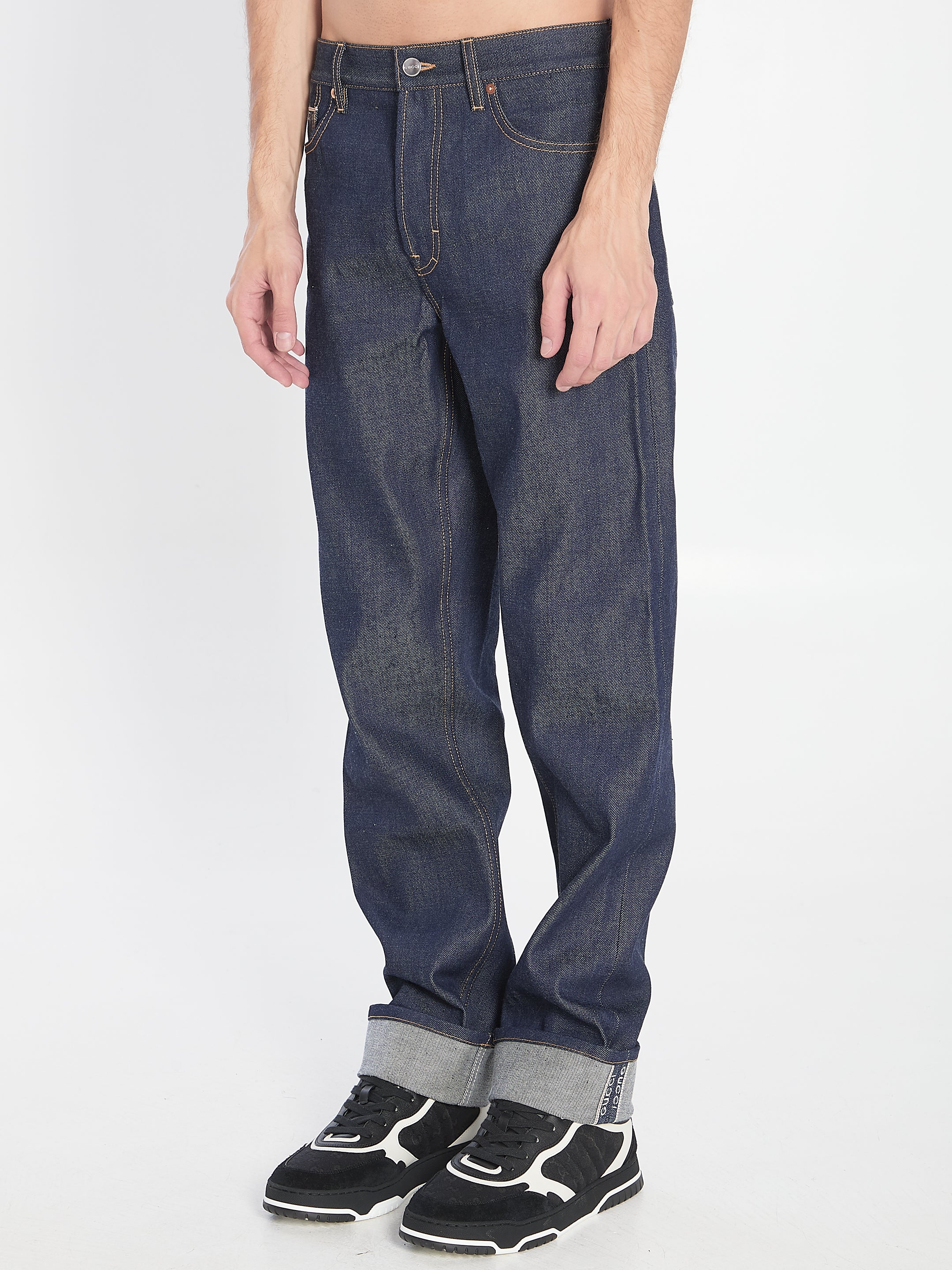 DENIM TROUSERS WITH HEM DETAILS Gucci