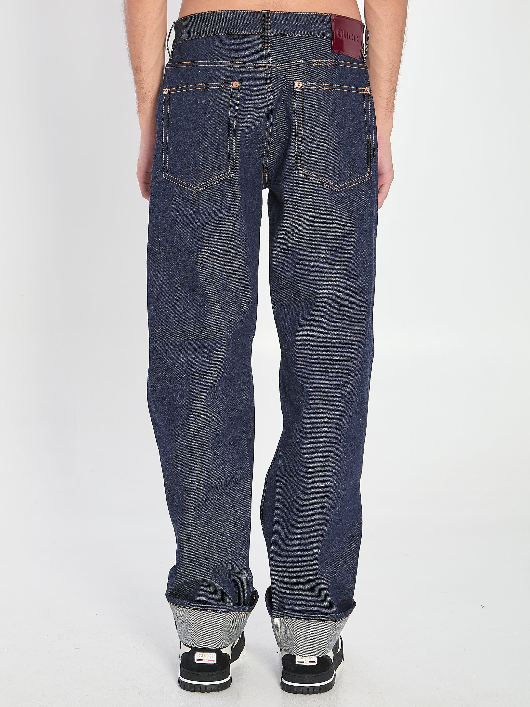 DENIM TROUSERS WITH HEM DETAILS Gucci