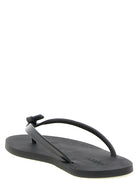 Black leather Pool flip flops by Saint Laurent, top view showing gold embossed logo