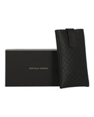 Black rectangle-frame sunglasses by Bottega Veneta, angled view
