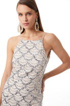 Ecru sequin halter dress on model, three-quarter view showing silhouette