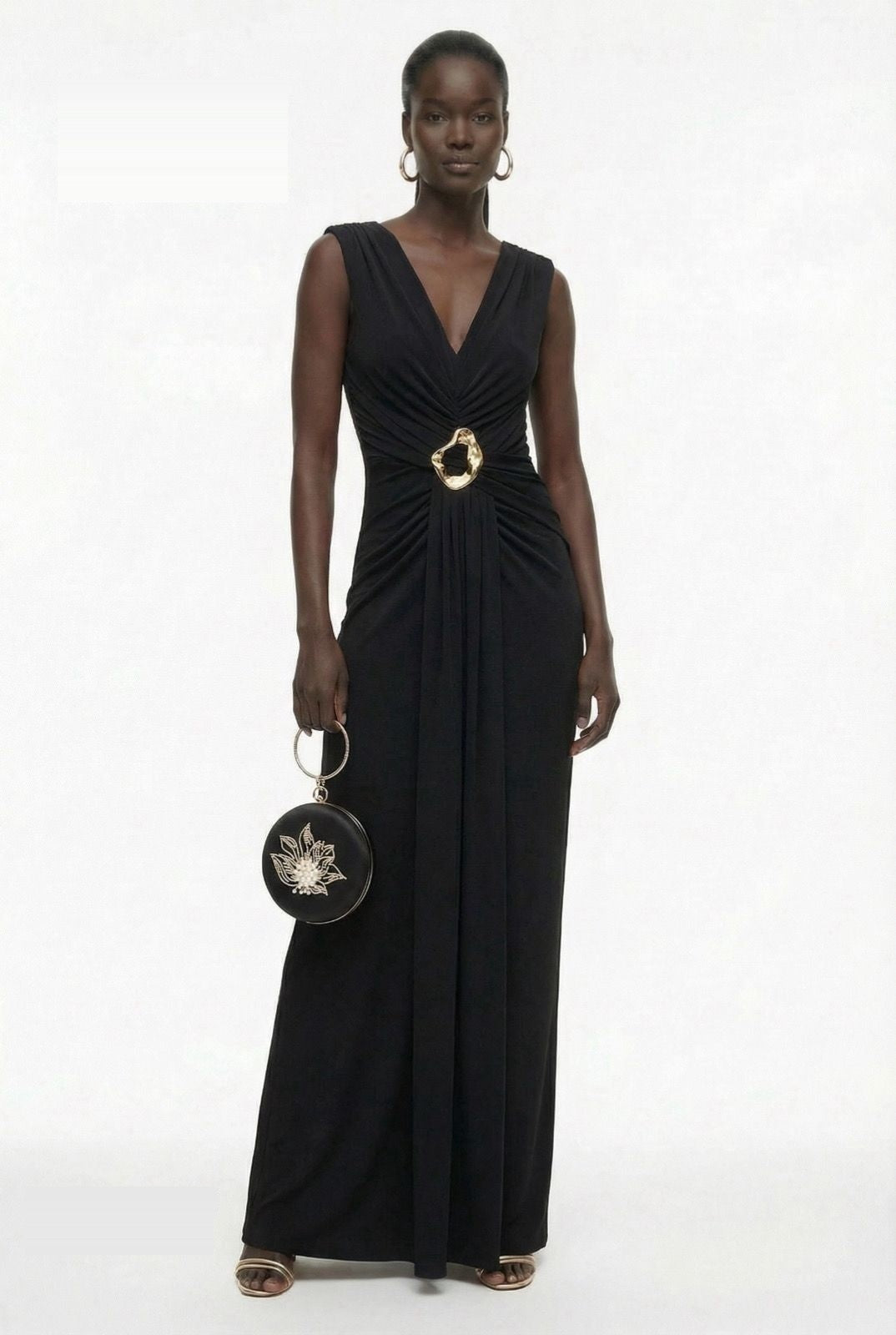 Black matte jersey gown styled with floral clutch and metallic heels by Lord & Taylor Heritage