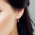 Blue sapphire and white sapphire hoop earrings worn, lifestyle view by Lord & Taylor