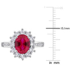 Oval created ruby center stone with white sapphire halo, close-up view by Lord & Taylor