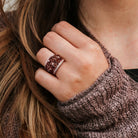 Smokey quartz gemstone cocktail ring with rose-tone plating worn on hand