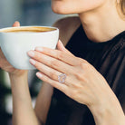 Unplated sterling silver diamond heart ring worn on hand, lifestyle view