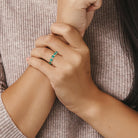 Created emerald semi-eternity ring in yellow-plated silver worn on hand by Lord & Taylor