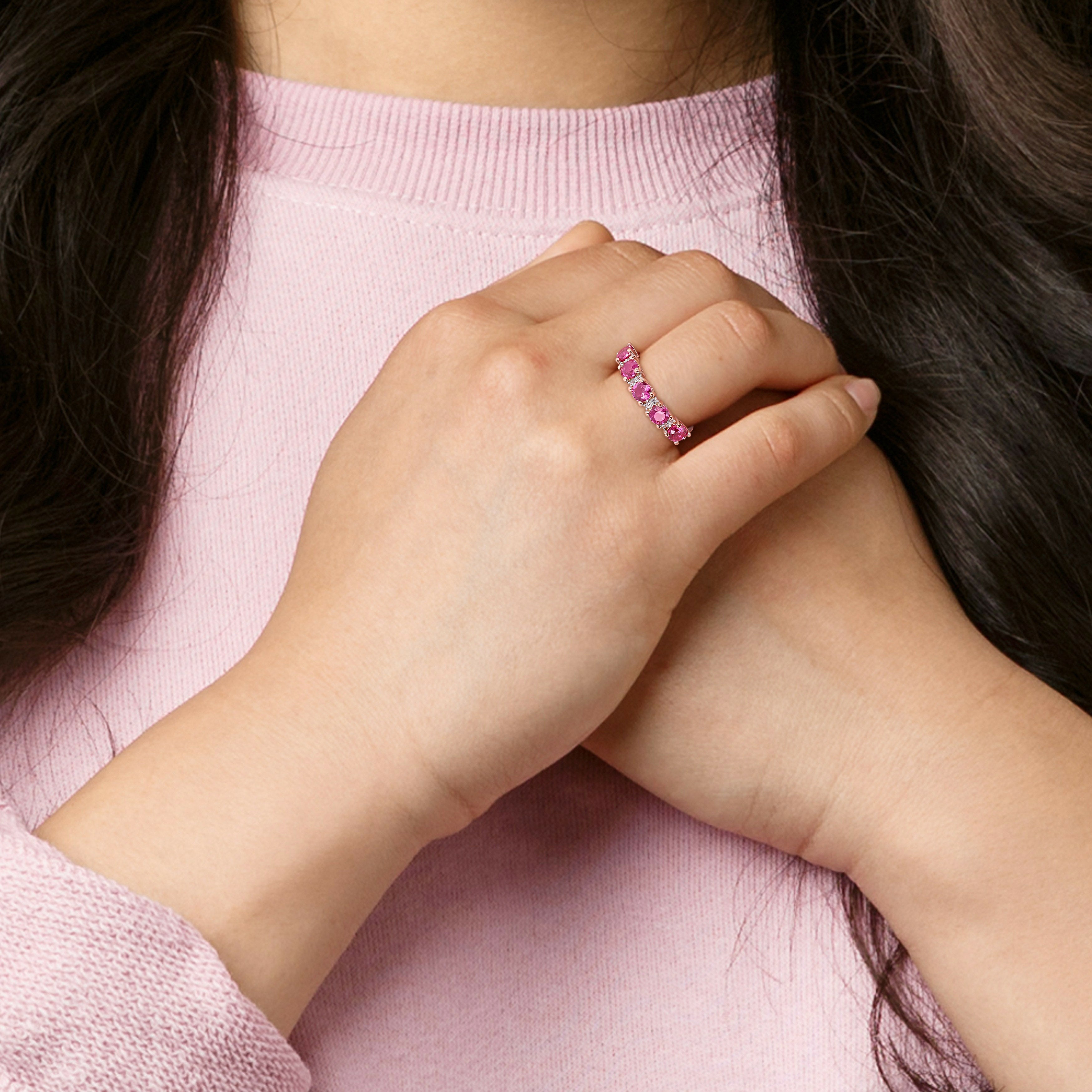 Created ruby semi-eternity ring in rose-plated silver worn on hand by Lord & Taylor