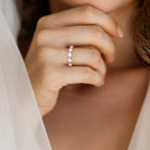 Sterling silver opal and white topaz ring by Delmar, worn on hand
