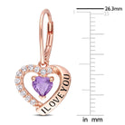 Close-up of heart-cut amethyst gemstone with white topaz halo and 'I Love You' engraving detail