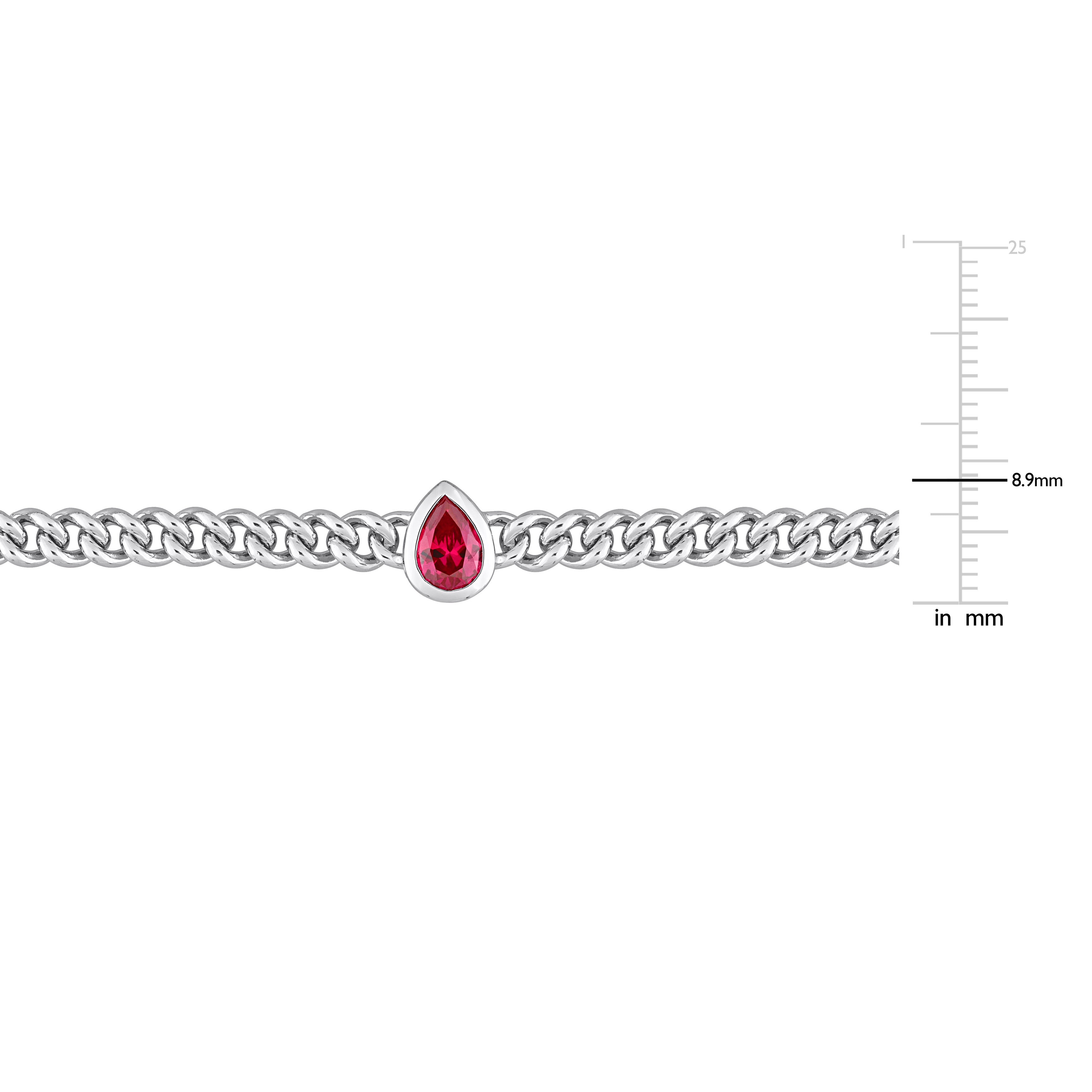 Close-up of pear-cut created ruby gemstone in bezel setting on sterling silver chain