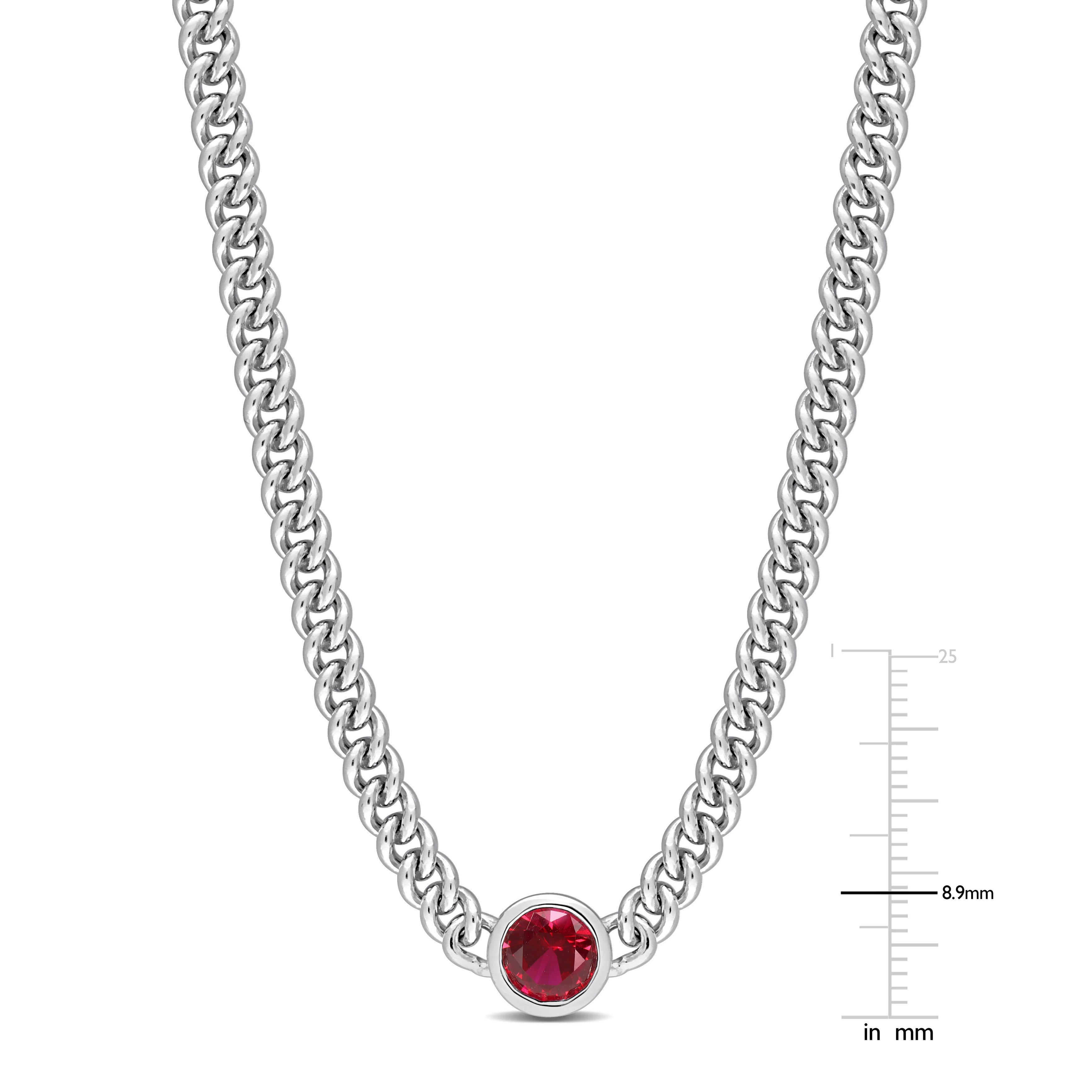 Close-up of 7mm round created ruby in bezel mount on sterling silver chain
