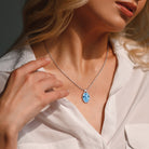Blue topaz sterling silver pendant necklace worn, lifestyle view by Lord & Taylor