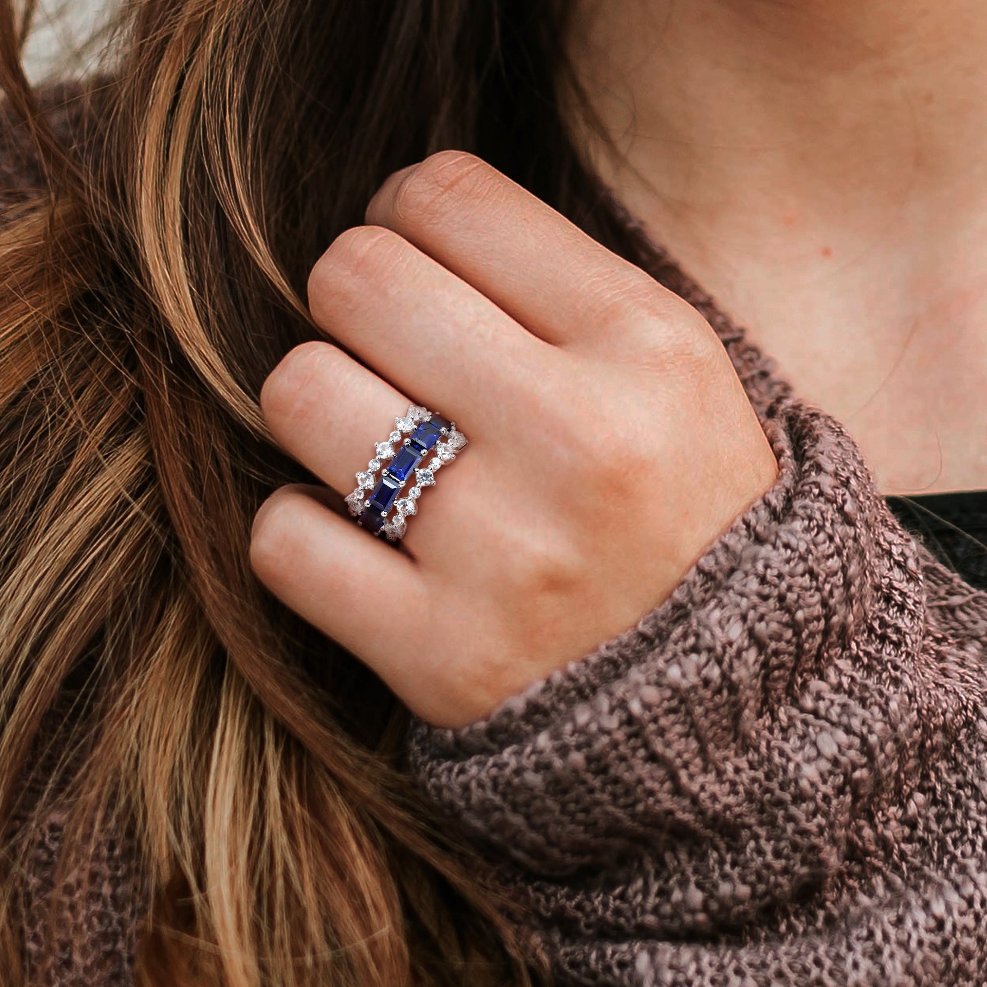 Sterling silver three-row sapphire ring worn on hand by Lord & Taylor