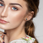 Black and white diamond halo stud earrings worn, lifestyle view