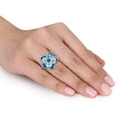 Blue topaz flower ring in sterling silver, side profile view