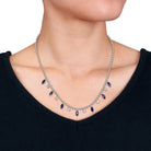 Close-up of marquise blue sapphire and round white sapphire charms on sterling silver chain