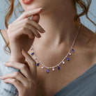 Sterling silver sapphire charm necklace by Lord & Taylor worn on model