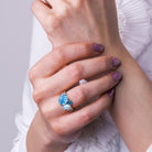 Blue topaz three-stone ring in sterling silver worn on hand by Lord & Taylor