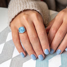 Blue topaz sterling silver ring worn on hand by Lord & Taylor