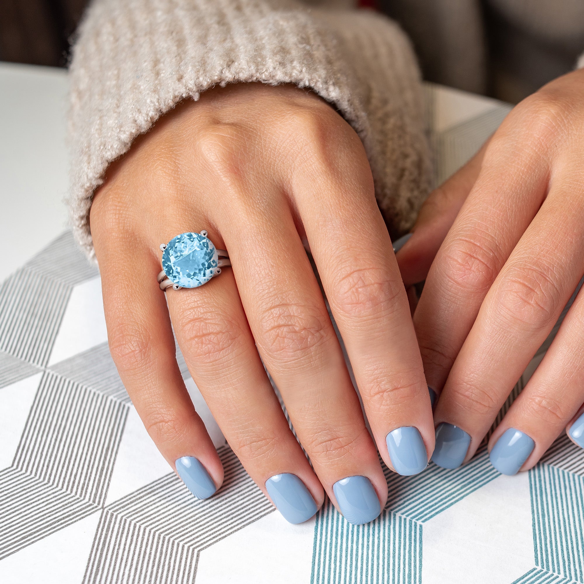 Blue topaz sterling silver ring worn on hand by Lord & Taylor