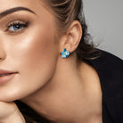 Blue topaz cluster stud earrings worn on ear by Lord & Taylor