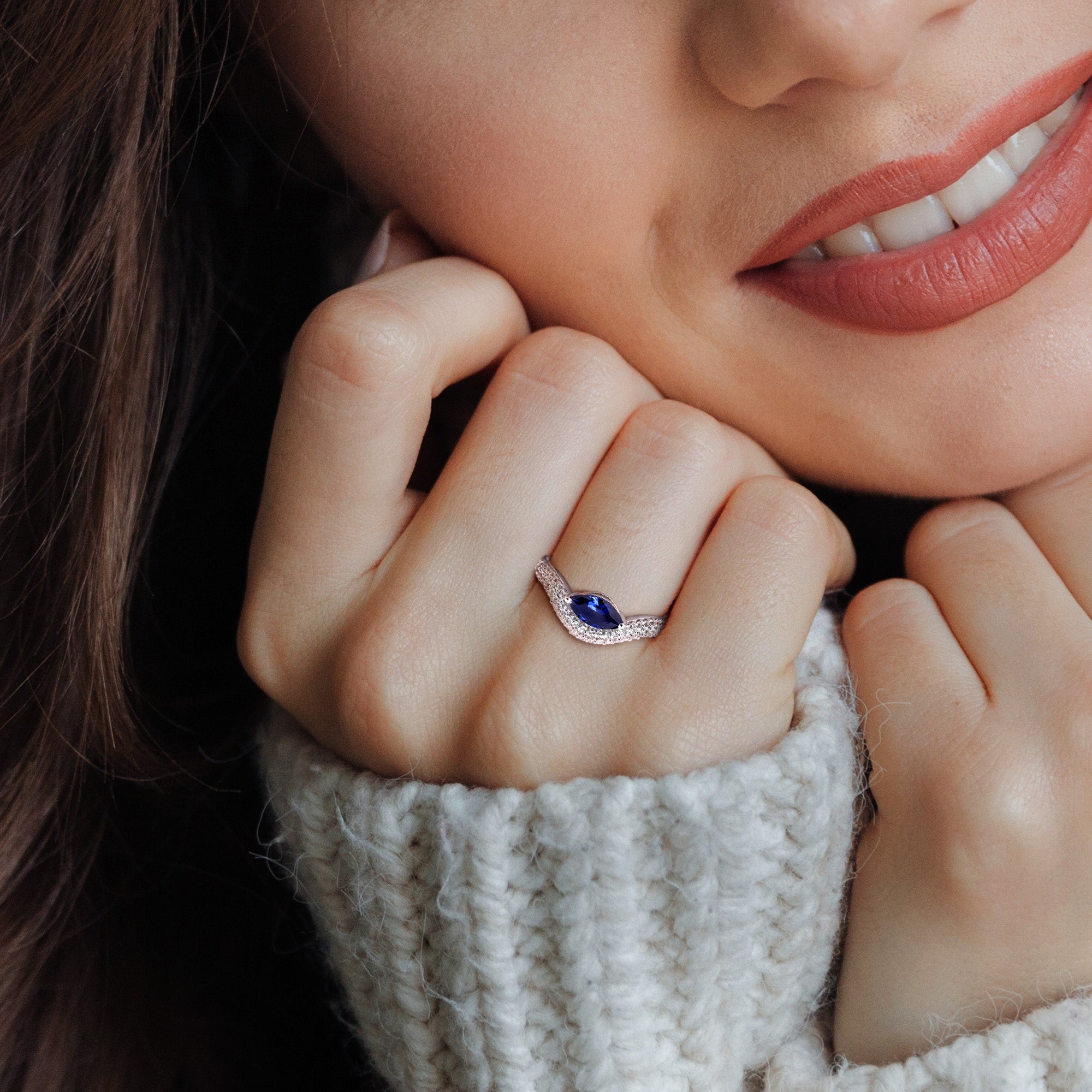 Blue sapphire curved ring in sterling silver worn on hand, lifestyle view by Lord & Taylor