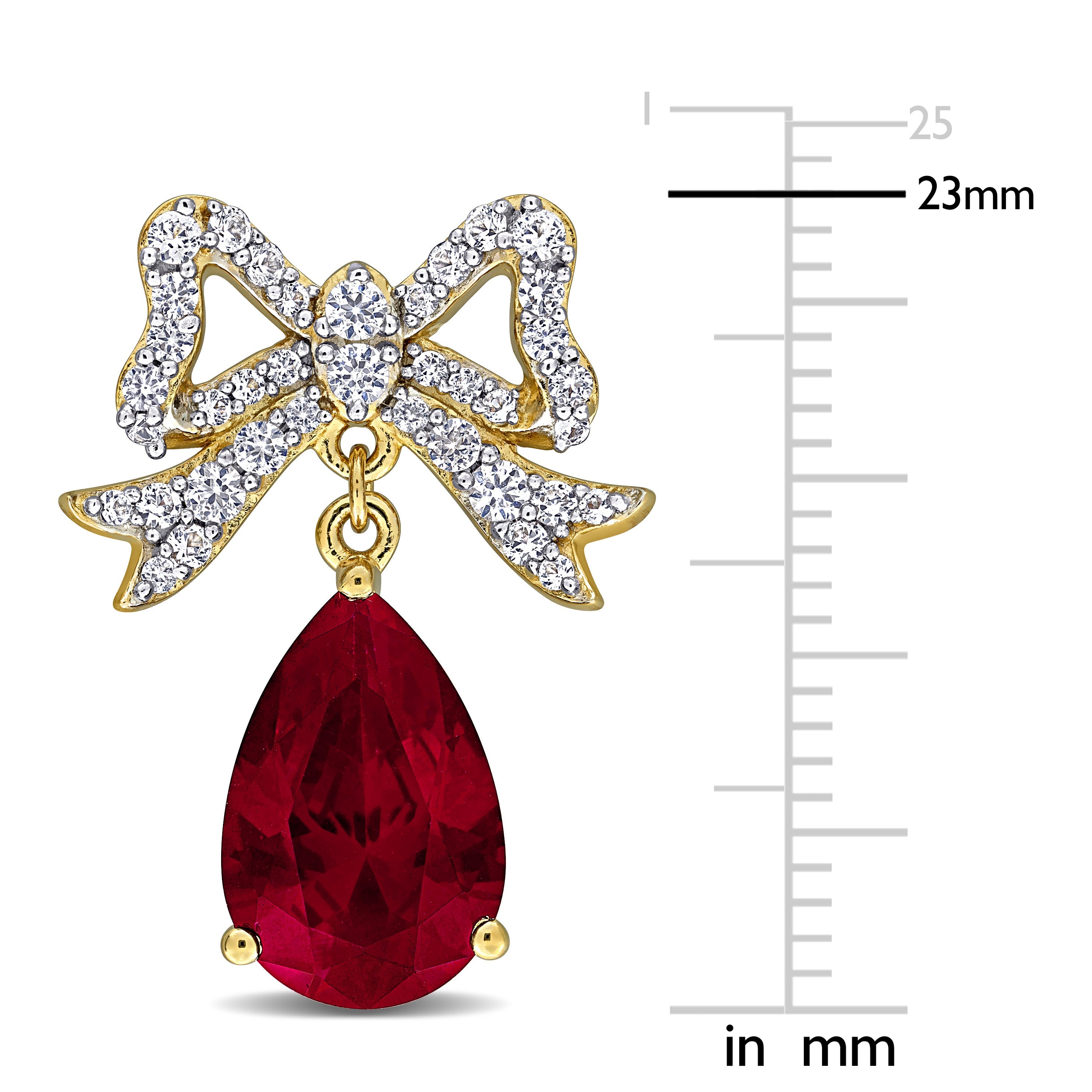 Close-up of created ruby and white sapphire bow detail in yellow plated sterling silver