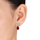 Lord & Taylor ruby drop earrings with bow design, side angle view showing pear-shaped stone