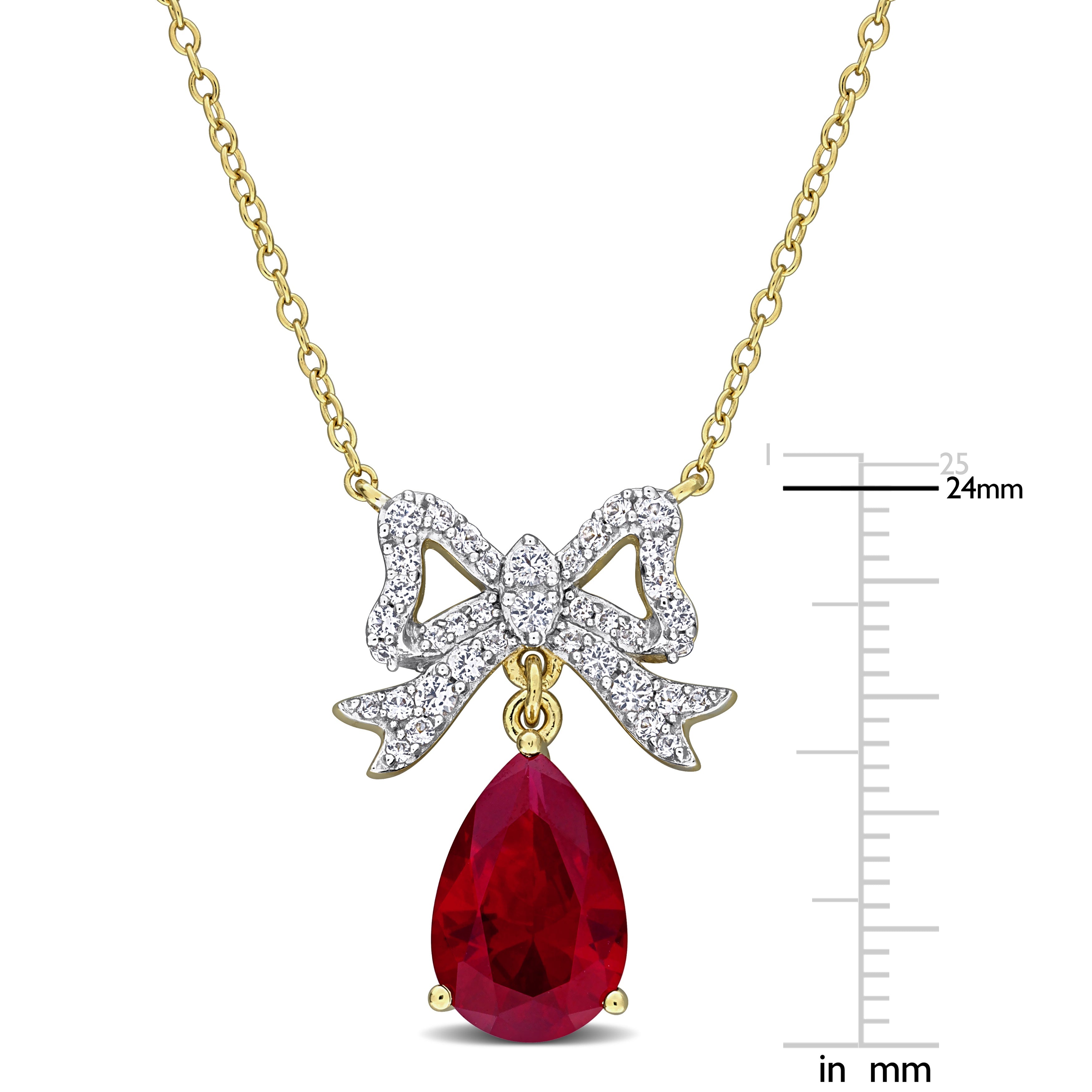 Close-up of bow pendant showing created ruby and white sapphire arrangement with high polish finish