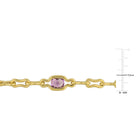 Close-up of purple amethyst gemstone in yellow-plated silver setting