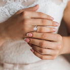 Sterling silver oval halo engagement ring worn on hand, lifestyle view